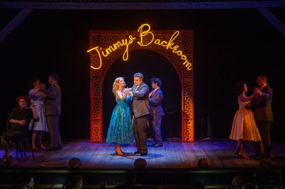 Deep red-lit stage moment from White Christmas